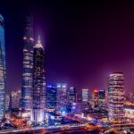 Majestic view of Shanghai's illuminated skyline featuring iconic skyscrapers at night.